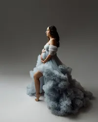 Pregnant mom in a flowing blue tulle gown posing in profile, highlighting her baby bump during a maternity photoshoot by Kaitlyn Dawn Photography in the Inland Empire.