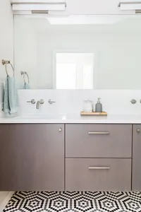 Fresh modern bathroom remodel with floating vanity and hex floor tile - Interior design by Patina Living Co.