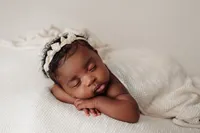 newborn Aubrey in knit wrap and headband during luxury studio session at CG Photography North Hollywood