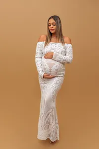 pregnant woman in lace gown posing during luxury maternity photography session