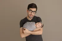 father cradling newborn during studio photoshoot in North Hollywood