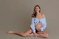 pregnant woman sitting gracefully during studio maternity portrait in North Hollywood