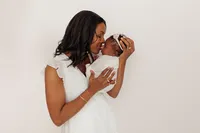 mom and newborn baby touching noses in intimate portrait during luxury photoshoot in Burbank