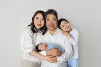 family portrait with newborn baby during studio photoshoot