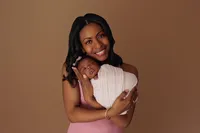 baby Aubrey with mom during intimate newborn and family session at CG Photography