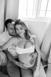 pregnant couple embracing each other during in-home maternity photo session in Los Angeles