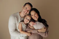 newborn baby with parents and older sister during family newborn portrait session in Los Angeles