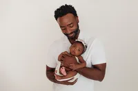baby Aubrey with dad during intimate newborn and family session at CG Photography