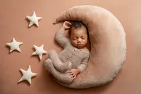 sleeping newborn baby posed with moon and star props