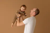 candid moment of father and son during studio maternity photoshoot in Burbank