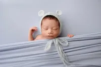 sleeping newborn Gio in light blue wrap during fine art studio session in North Hollywood