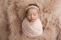newborn baby on pink fur blanket during fine art portrait session in North Hollywood