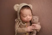 baby Gio posed with teddy bear during luxury newborn photography session in Los Angeles