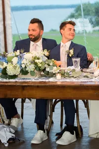 Grooms laughing at the head table