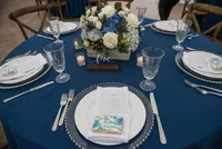 Navy place setting with a white floral centerpiece