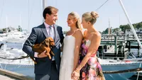 Patty and Cooper laughing together at the marina on their wedding day in Rockport, Maine
