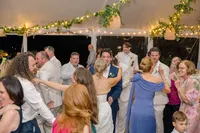 Guests dancing under the tent at night