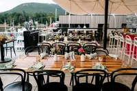Harborside welcome dinner tables set with florals on Camden Harbor