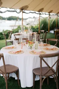 Round table set with rattan chairs and florals