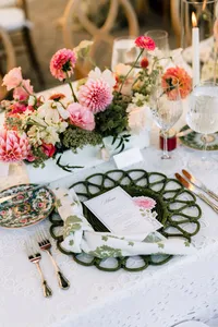 Long reception table with pink florals, gold flatware and vintage china