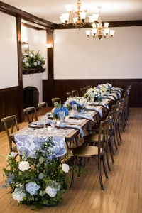 Reception room set with long tables and chandeliers