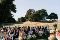 Guests gathered on the lawn under the trees for the Samoset Resort wedding ceremony