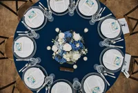 Overhead view of a round table set in navy and white