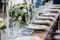 Long reception table with white florals and blue accents