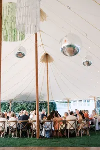 Hanging florals and disco balls inside the tent