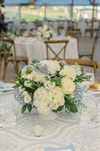 White floral centerpiece on a blue linen