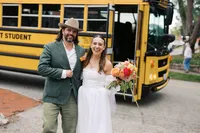 Couple arriving by yellow school bus