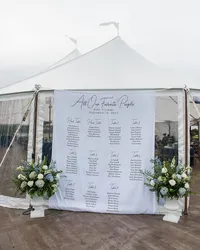 Seating chart display framed with white florals