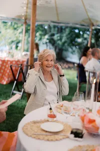 Guest smiling at dinner under the tent