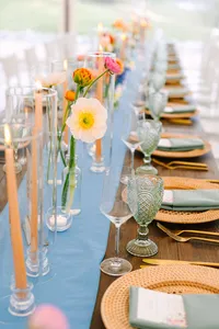 Tablescape with tall tapers, bud vases and blue napkins