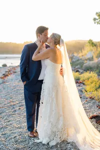Couple kissing on the rocky shoreline