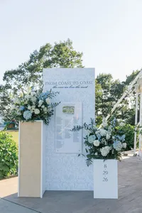 White seating chart display framed with florals
