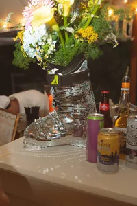 Bar display with florals and glassware under the tent