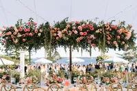 Tented reception with hanging floral installations above the tables