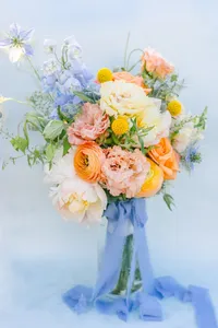 Pastel bridal bouquet tied with blue silk ribbon