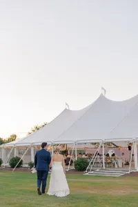 Couple walking toward the sailcloth tent