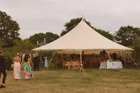Sailcloth tent set up on the lawn for the reception