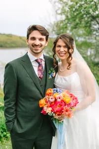 Bride and groom smiling together on the lawn