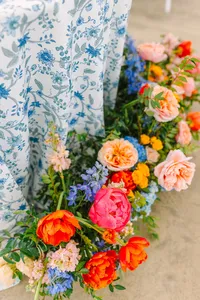 Flowing floral arrangement cascading over a blue chinoiserie linen