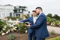 Grooms celebrating as they walk back up the aisle