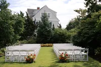 Ceremony chairs set on a garden lawn
