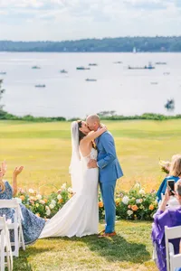 Couple embracing at the ceremony overlooking the bay