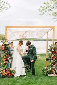 Couple at the floral arbor with Penobscot Bay behind them