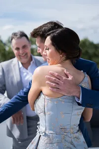 Wedding guests sharing a joyful hug during the wedding weekend at French's Point