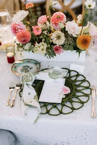 Reception tablescape with garden roses and green woven chargers