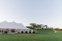 Sailcloth tent on the lawn above the bay
